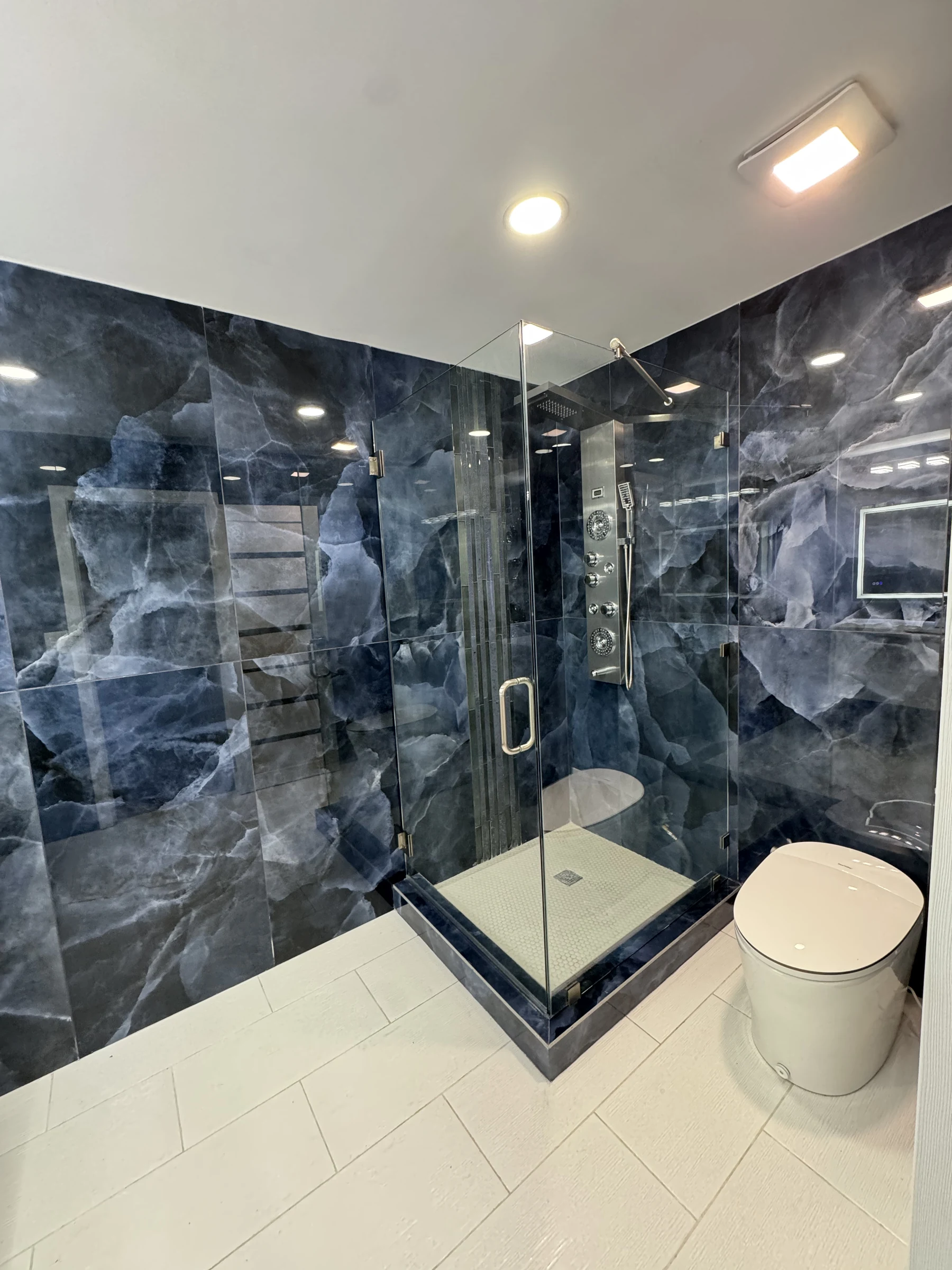 Walk-in shower with blue onyx walls in Manhattan Beach