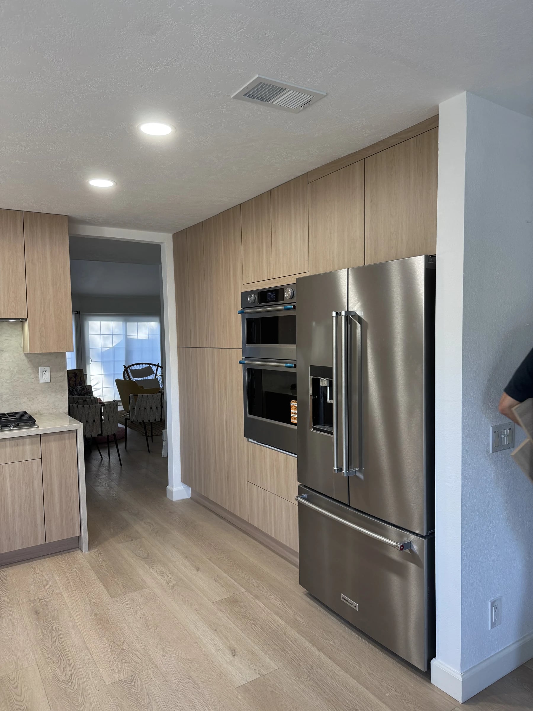 Kitchen with an oak panel wall, stainless appliances and a plank floor in Glendale