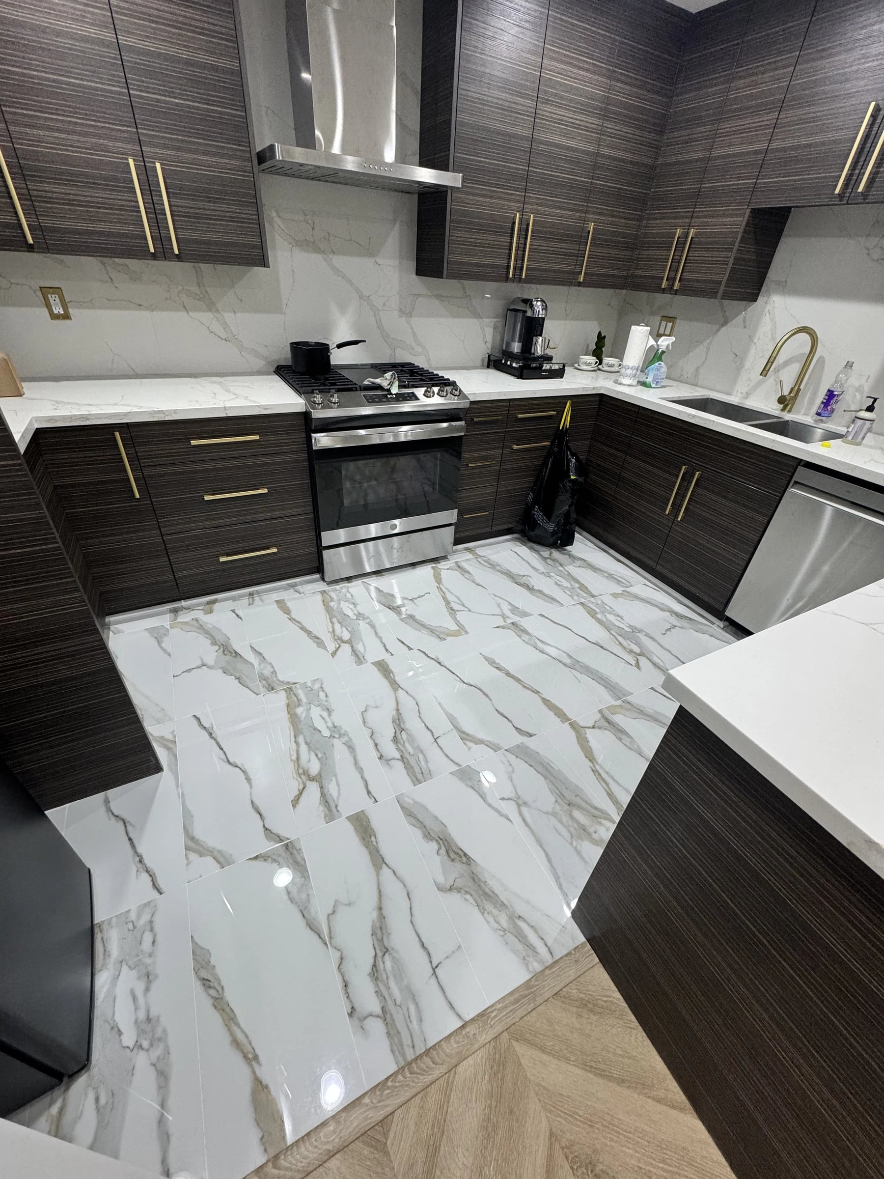 Kitchen with walnut cabinets and marble-look tile floor in Irvine