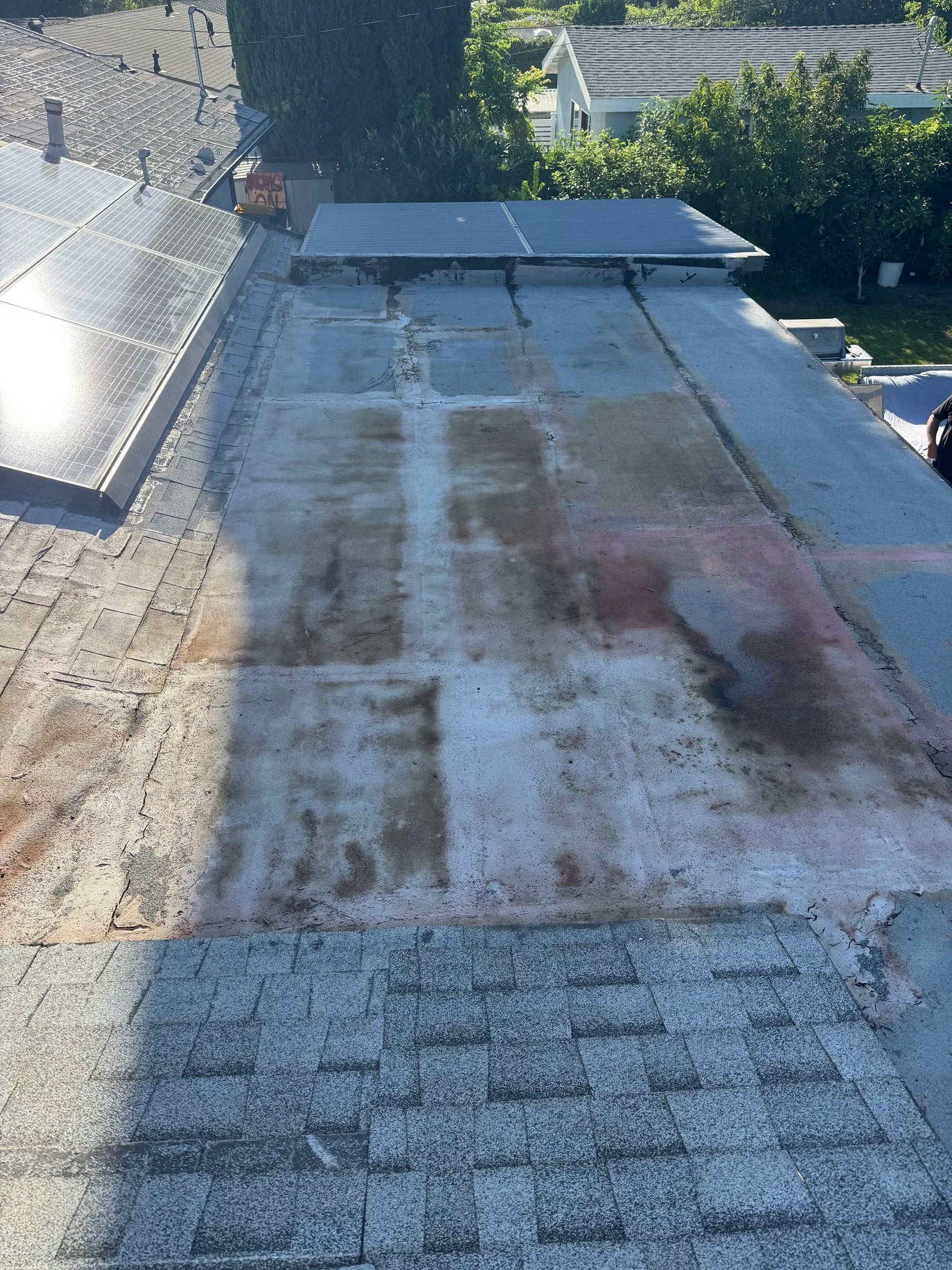 Flat roof before coating, weathered and patched in Burbank